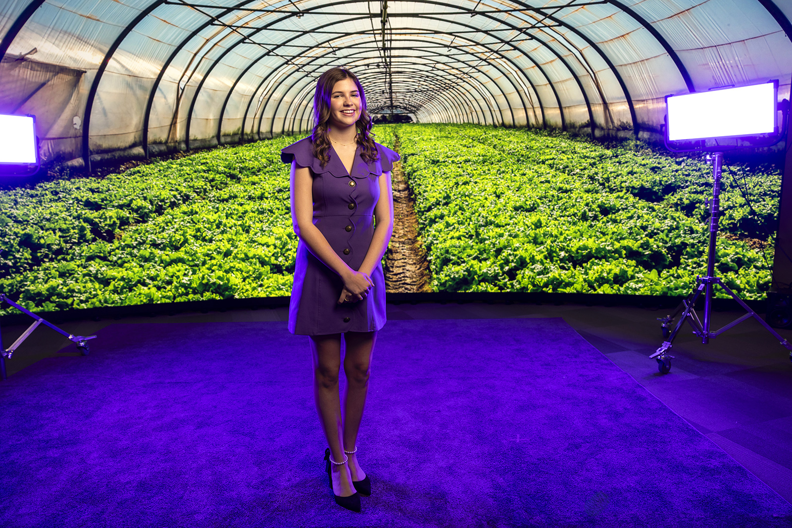 Emilee Bollock portrait with greenhouse backdrop