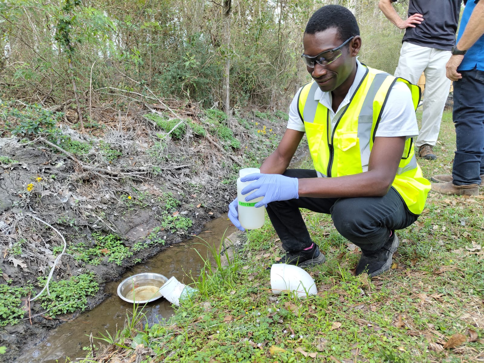 Ebenezer Etsiwah collects water samples.