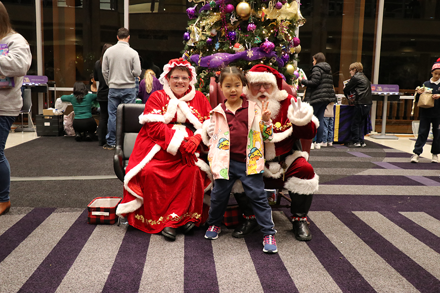 child with Santa and Mrs. Claus