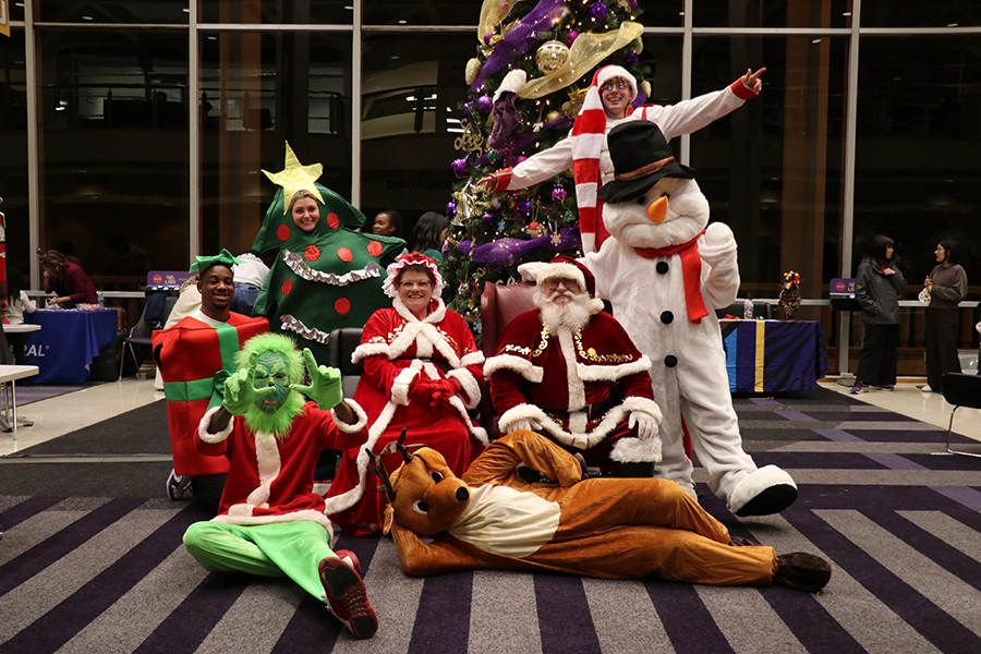 costumed staff with Santa and Mrs. Claus